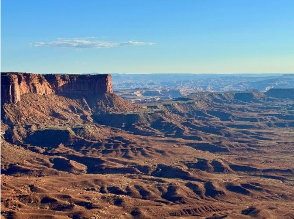 A view of the overlook: there are canyons spanning miles into the distance, showing off a vast and beautiful landscape.