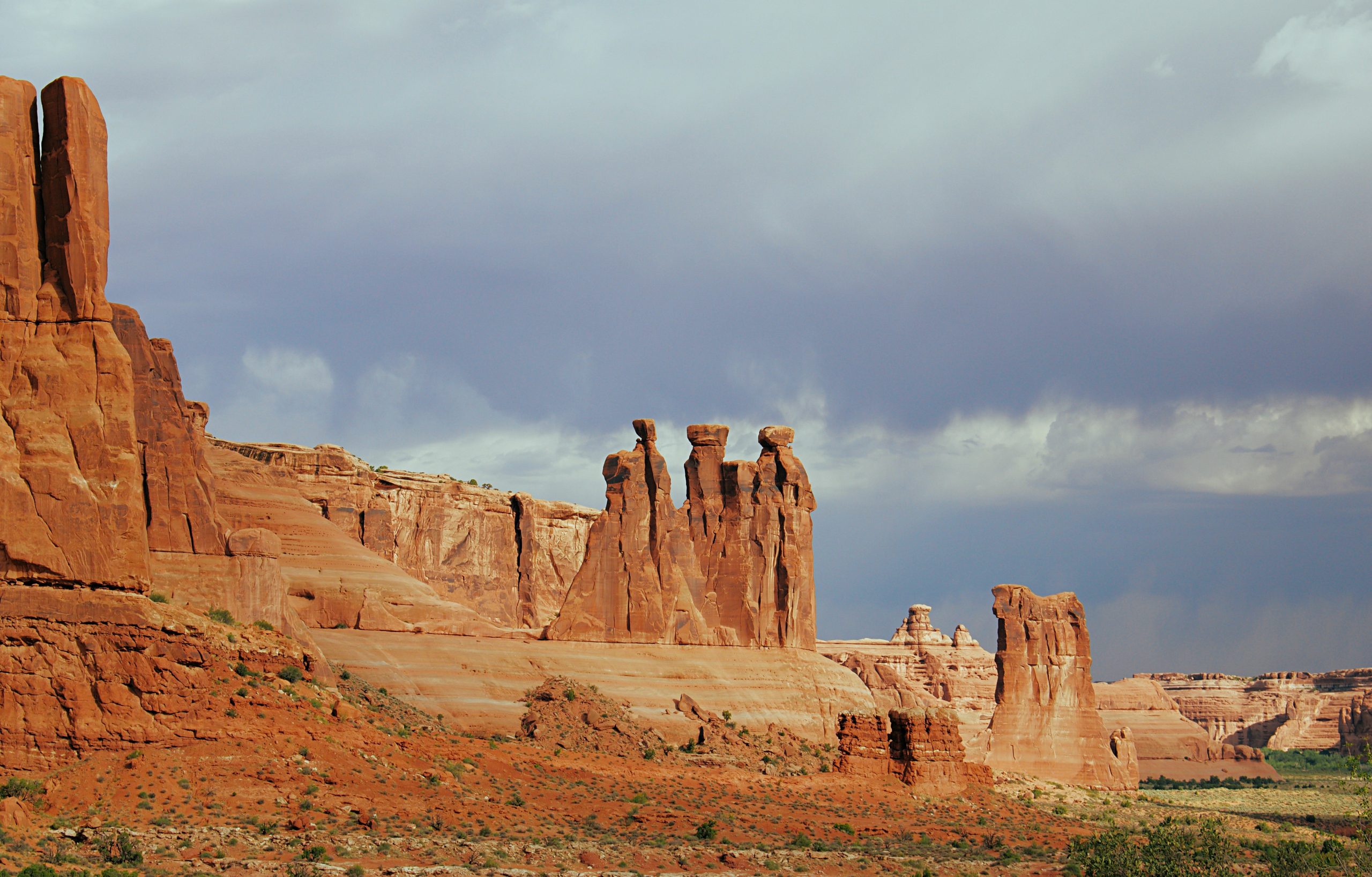 The Three Gossips pictured with a storm in the background